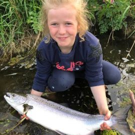 young girl holding a salmon
